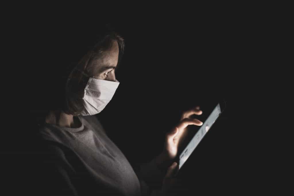 Lady with mask watching video